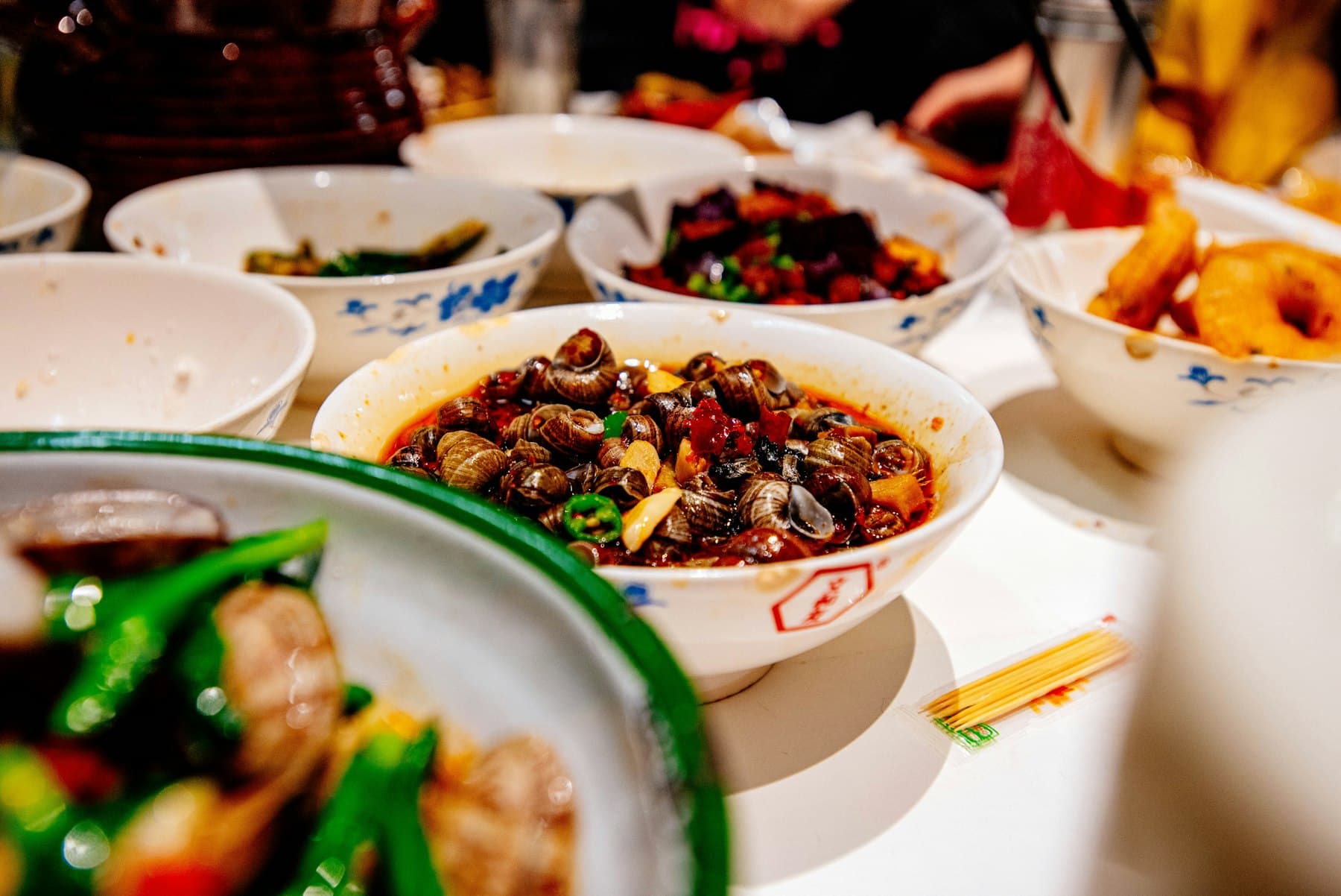 A large table of shared Chinese dishes
