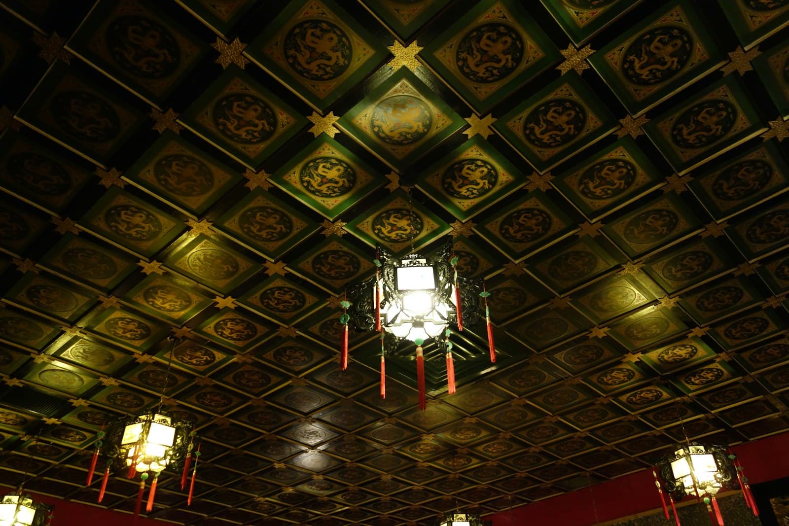 An ornate ceiling with hanging lanterns