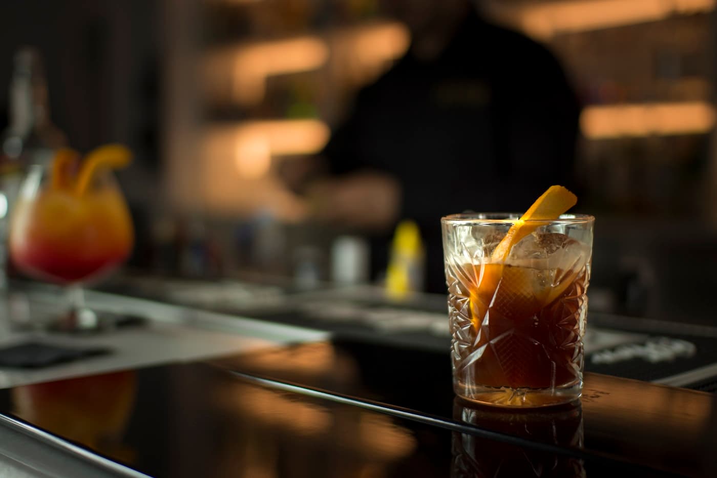 Cocktails on a dark bar counter
