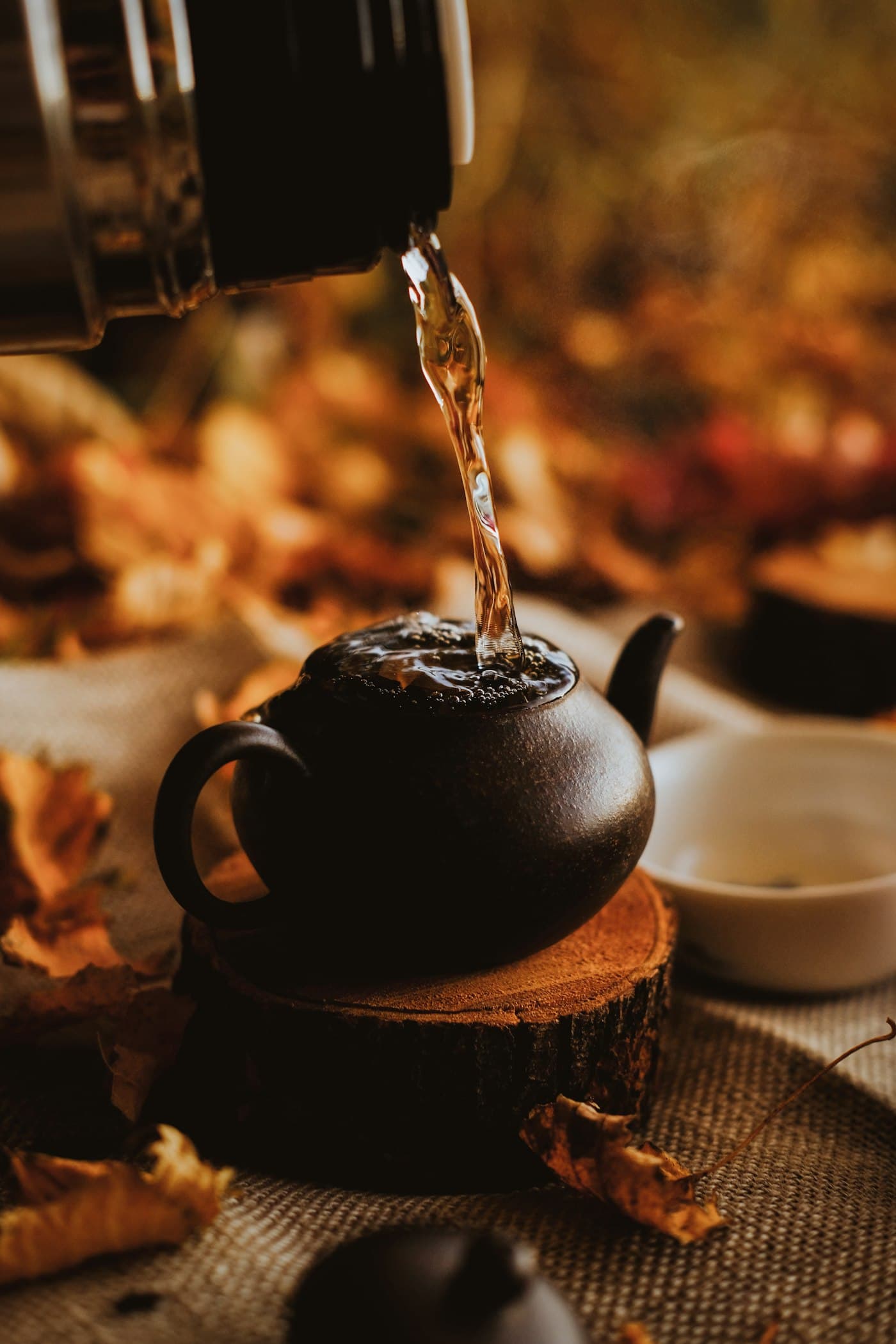 Tea being poured from a clay teapot
