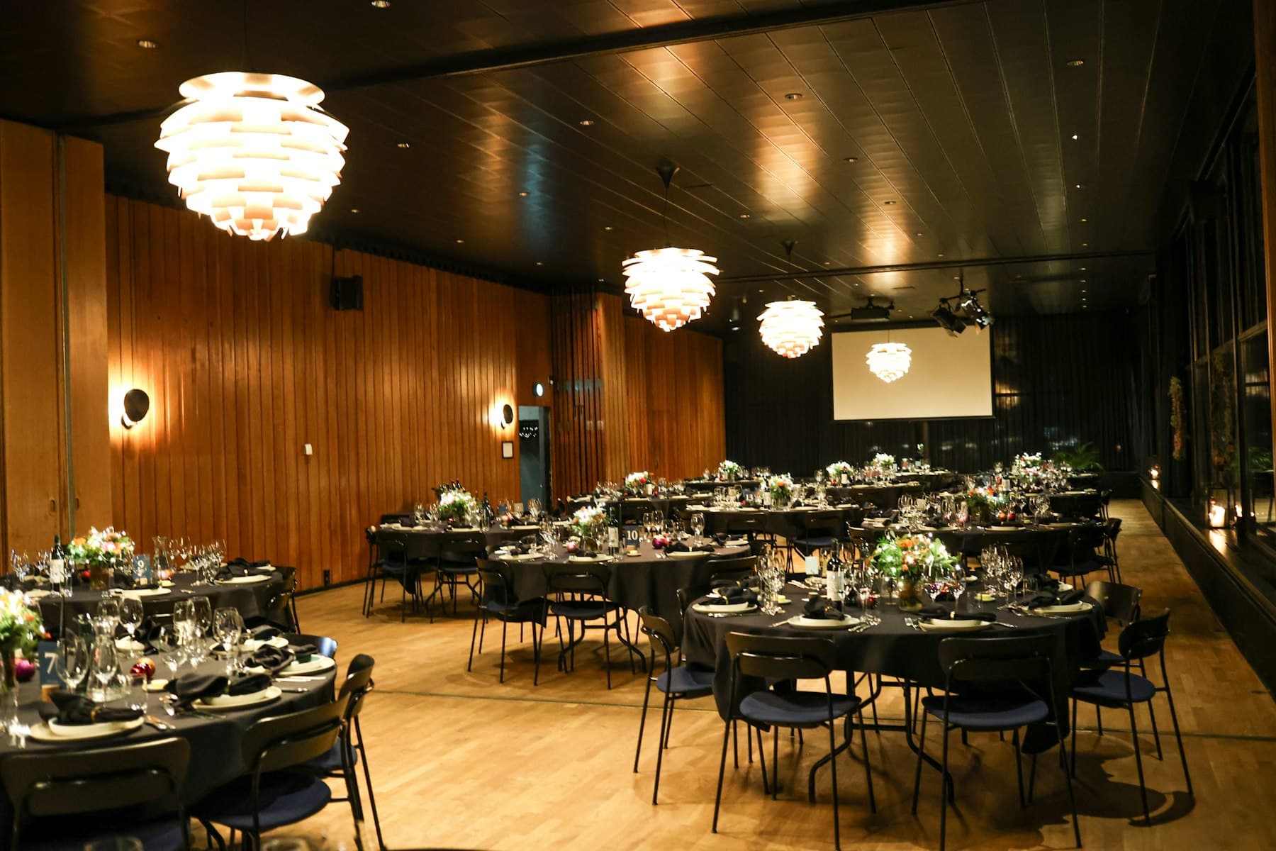 Round banquet tables laid for a large party