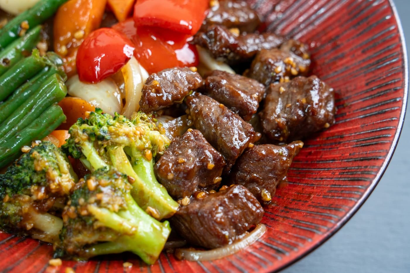 Twice-cooked pork with peppers and vegetables on a red plate