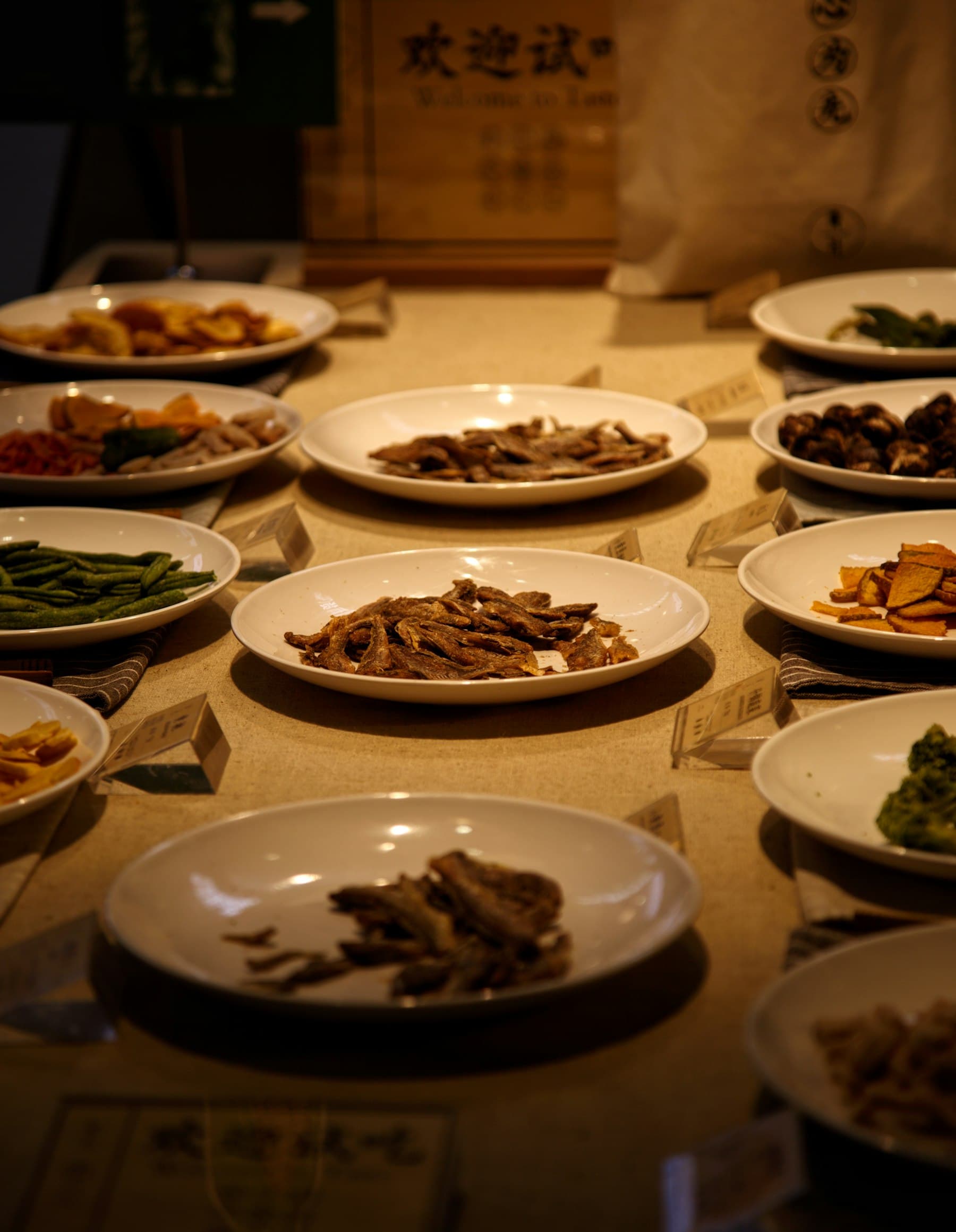 Small Chinese dishes laid out under warm light